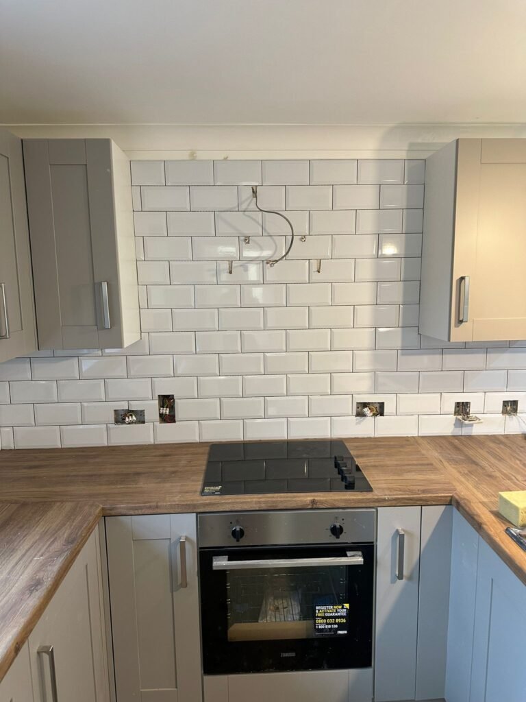 Kitchen worktop area tiled, oven installed