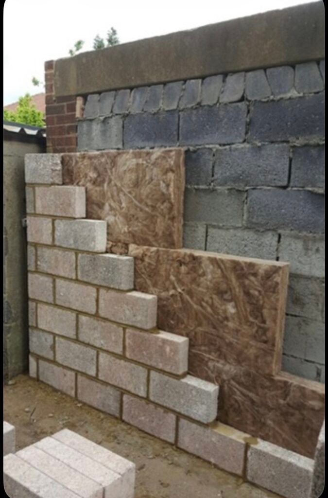 Block wall and insulation being put up