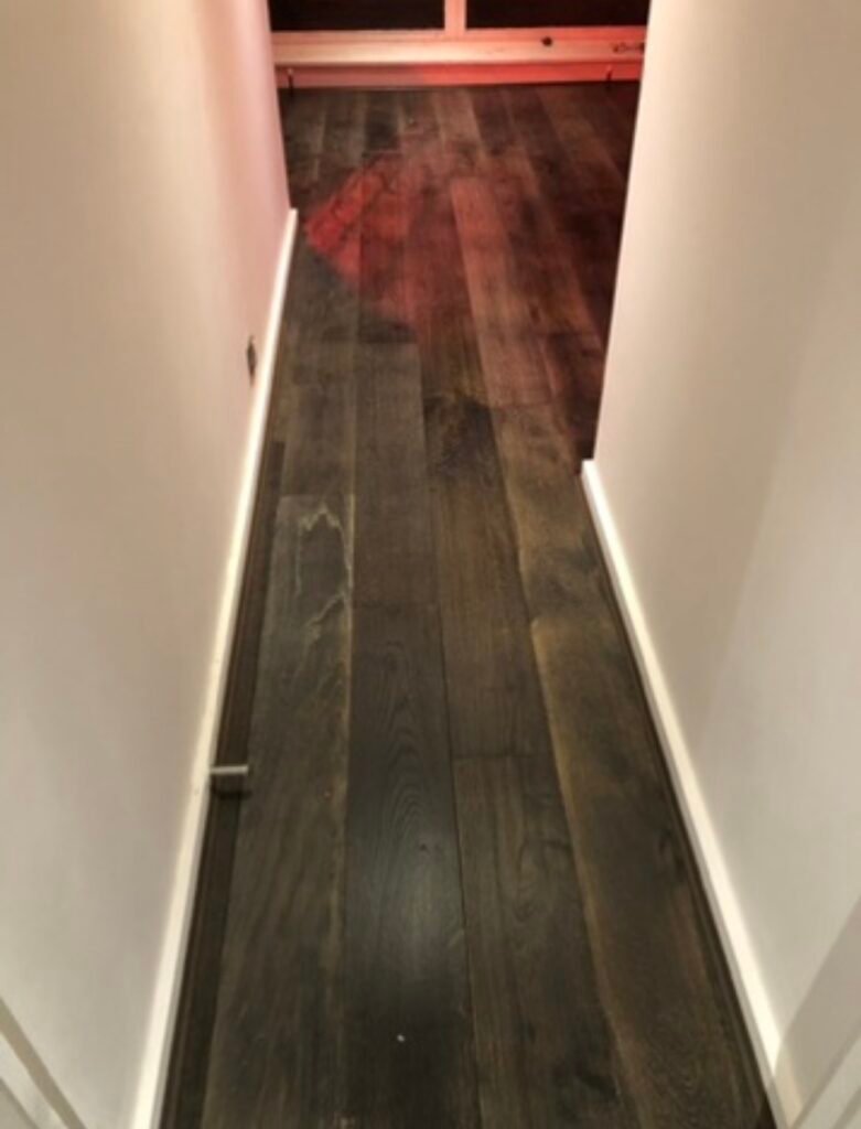 New dark engineered wood flooring laid